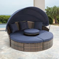 Lit de repos rond d'extérieur en rotin avec auvent, table basse